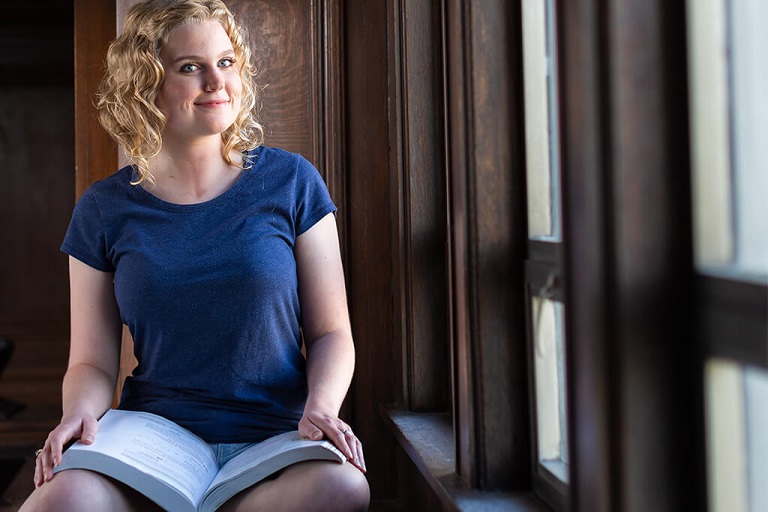person of color women on couch with computer