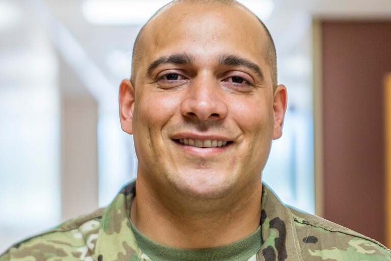 person of color women on couch with computer