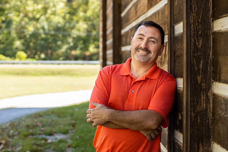 billy leaning on house